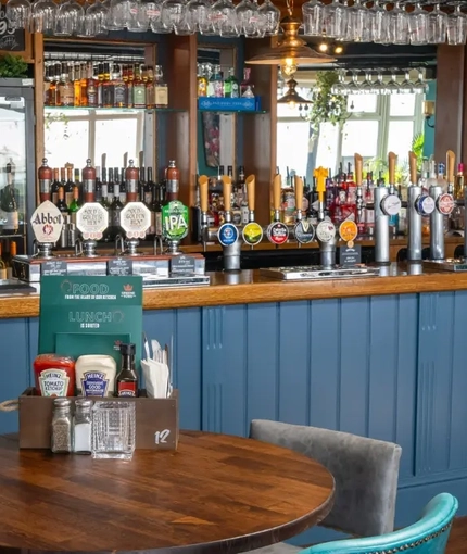 The interior bar with restaurant and seating area at The Commodore.