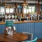 The interior bar with restaurant and seating area at The Commodore.