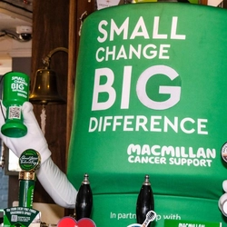 A person dressed up in a giant MacMillan collection Tin costume.