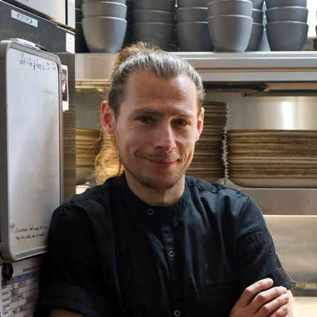 Staff member stood in the kitchen posing for a photo.
