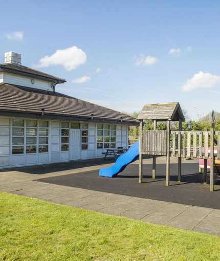 Exterior play area of a pub with a seating area.