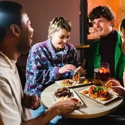 Friends enjoying food and drink at the pub