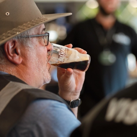 An image of a person drinking a stout drink at The Belhaven Brewery.
