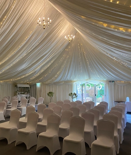 A marquee, decorated for a wedding.