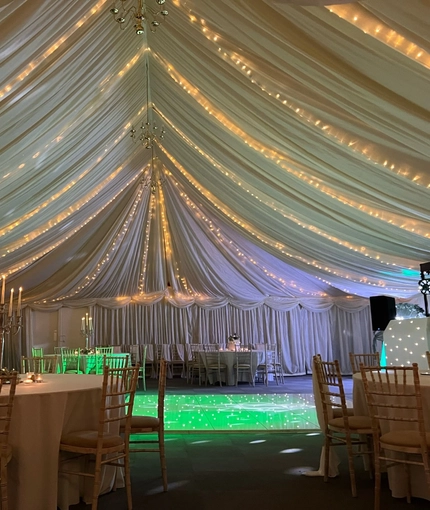 A marquee, decorated for a wedding.