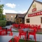 The exterior of the venue and beer garden seating area with tables, chairs, venue signage and string lighting at The Castle View.