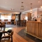 Interior dining area of a pub with a bar and a TV.