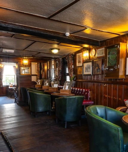 The interior restaurant seating area of Ye Olde Mitre in Barnet.