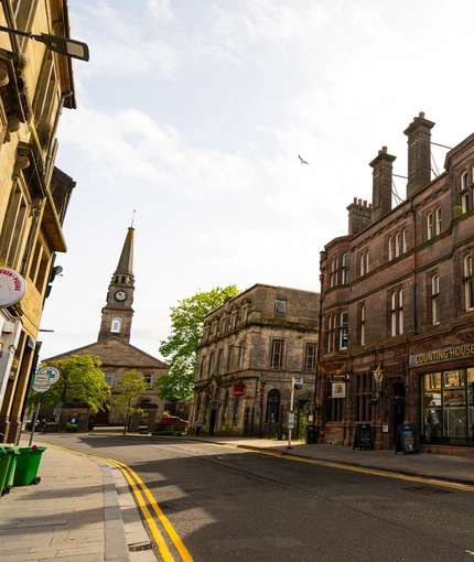 A view from across the road of the exterior facade and signage of the Counting House in Dumbarton.