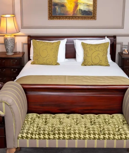The interior hotel master bedroom with a king size bed at the Cedars in