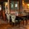 The interior restaurant seating area at The Rising Sun in Wistaston, with wood panelled walls, and wooden beams on the walls and ceiling.