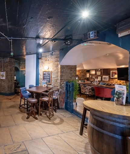 The bar in the Prince Of Wales, and some tables near to it.
