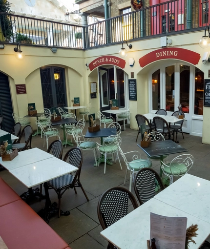 Interior of main dining area with several tables with menus & dining chairs