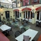 Interior of main dining area with several tables with menus & dining chairs