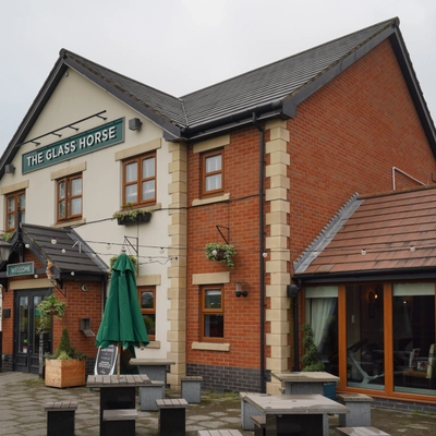 Exterior facade of a pub with a seating area.