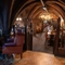 The interior bar and multi level restaurant seating area with tables, chairs, gothic stone vaulted ceiling and tiled flooring at The Watergates Bar.