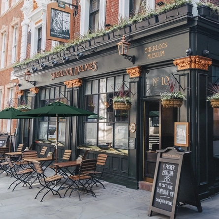 The exterior facade and seating area at the Sherlock Holmes.