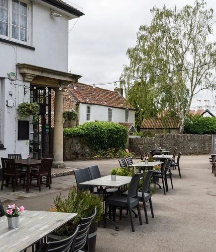 Exterior beer garden of a pub with a seating area.
