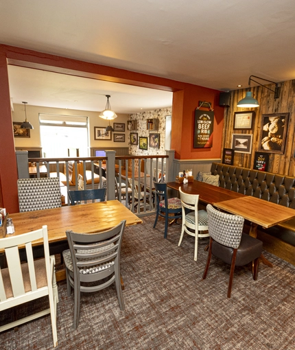 Interior dining area of a pub with a TV.