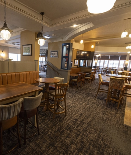Interior dining area of a pub with a TV.