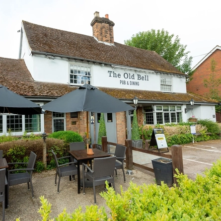 The exterior of The Old Bell and part of the beer garden.