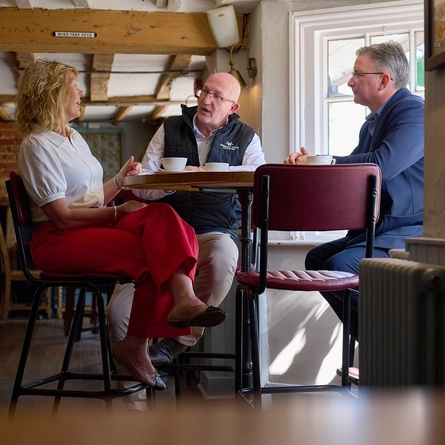 A Pub Partners image showing 3 people sat at a table within the Shinfield Arms.