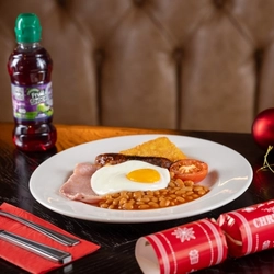 a plate of food sitting on a wooden table of a pub