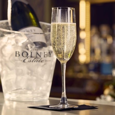 An advertising image of a glass of Prosecco from the Autumn/Winter menu available at The White Horses.