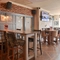 Interior dining area of a pub with a TV.