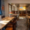 The interior restaurant seating area with tables, chairs, seating booths and wall mounted TV at The Castle View.