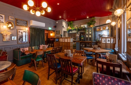 The interior restaurant seating area with bar at The Blue Posts.