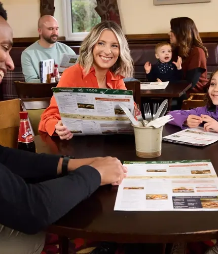 Family looking at the menu at a Farmhouse Inn