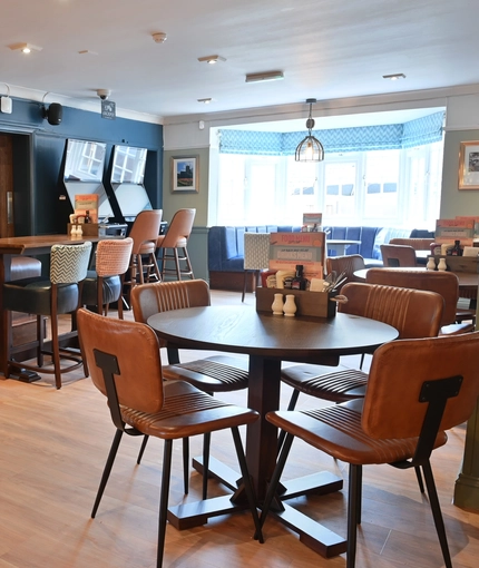 The interior restaurant seating area with TV and electronic pub games at The Greengage.