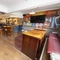 Interior dining area of a pub with a few TVs.