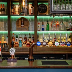 A close up view of the beer taps on the bar inside The Kittoch.