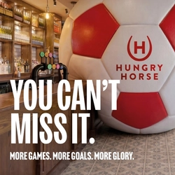 A banner promoting the new football season at Hungry Horse venues. The banner shows an interior of a Hungry Horse-branded sports bar featuring a giant football-shaped wall installation beside the bar. Large white text reads “YOU CAN’T MISS IT.” with smaller text underneath stating “MORE GAMES. MORE GOALS. MORE GLORY.” A television screen showing a football match is visible in the background above beer taps and shelves of bottles.