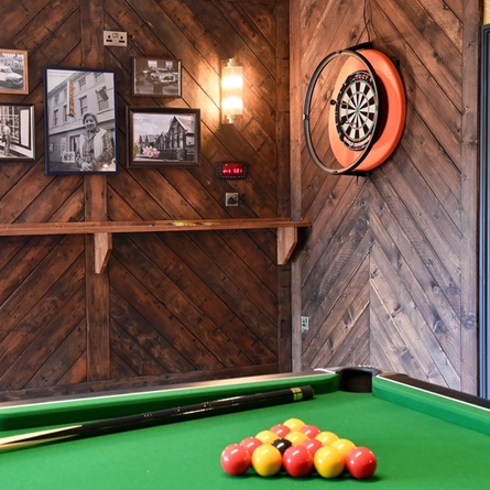 The interior games area with pool table and dartboard at The Kingfisher.