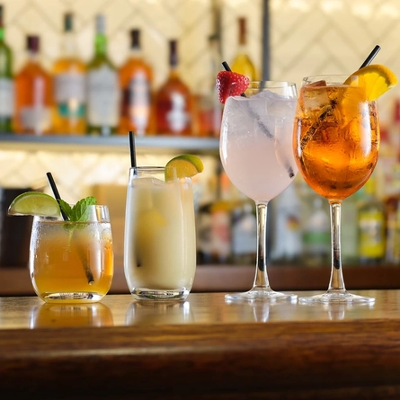 A few drinks sitting on a bar counter