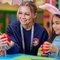 Children and an adult participating in Easter crafts.