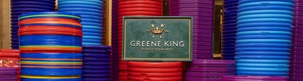 A image of stacked tubs including celebration, roses, quality street and heroes with a Greene King plaque in the middle.