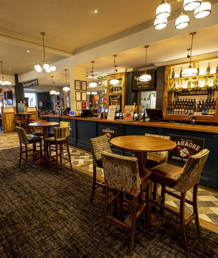 Interior dining area of a pub with a bar.