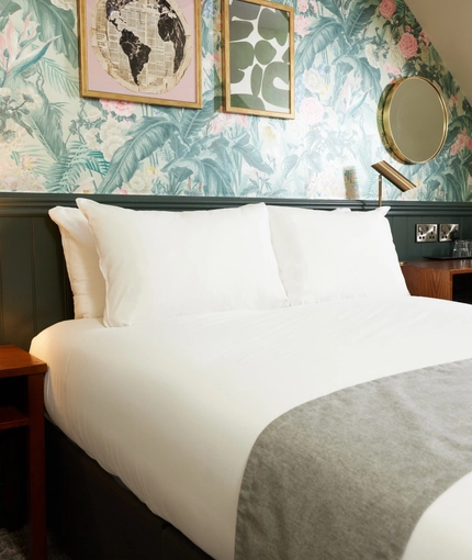 A bed in a hotel room of The Narborough Arms.