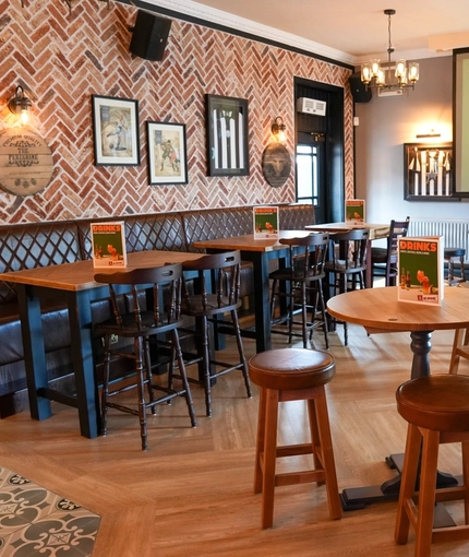 The interior restaurant seating area with TV at The Peregrine.