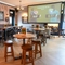 The interior restaurant seating area with TV at The Peregrine.