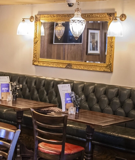 The interior restaurant seating area and TV at The Bull.