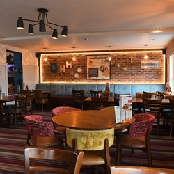 The interior restaurant seating area with feature fireplace at The Hussey Arms.