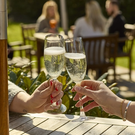 An image showing two glasses of Prosecco being enjoyed at Chef & Brewer.