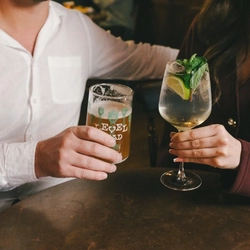 A couple enjoying drinks at a Greene King Heritage venue.