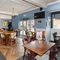 Interior dining area of a pub with a few TVs.