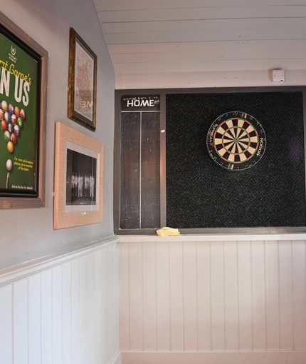 Interior area of a pub with a dartboard.